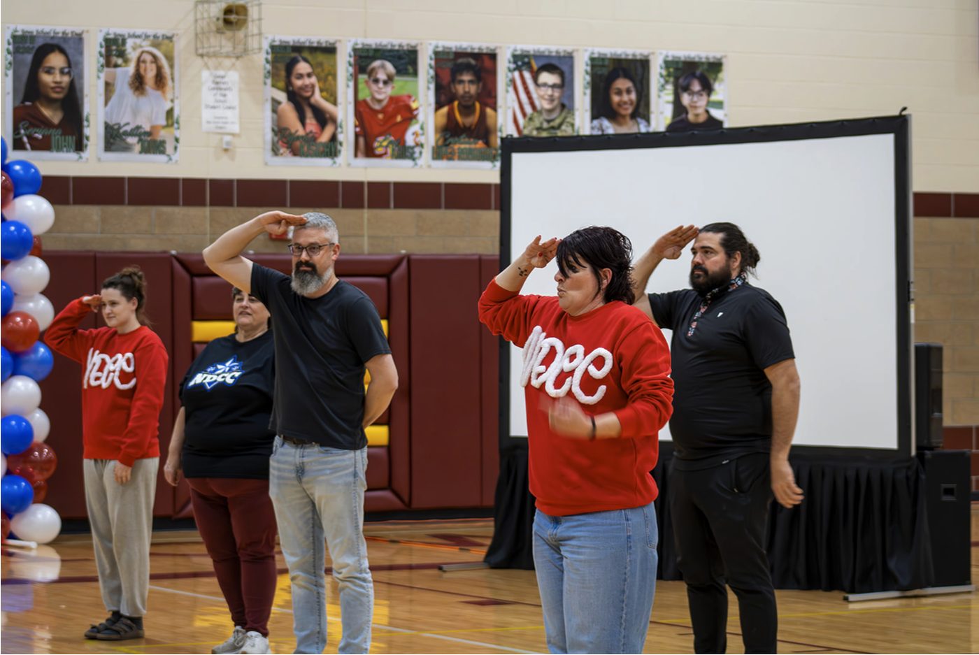 Staff and attendees sign the national anthem in American Sign Language at the National Deaf Cheer Competition, hosted by Iowa School for the Deaf.